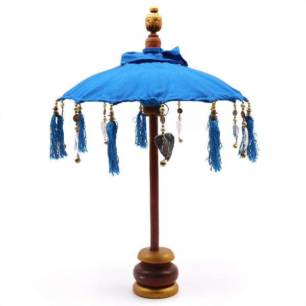 Decorative umbrella with blue canopy and tassels on a white background