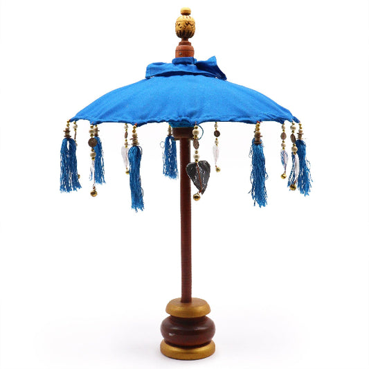 Decorative umbrella with blue canopy and tassels on a white background
