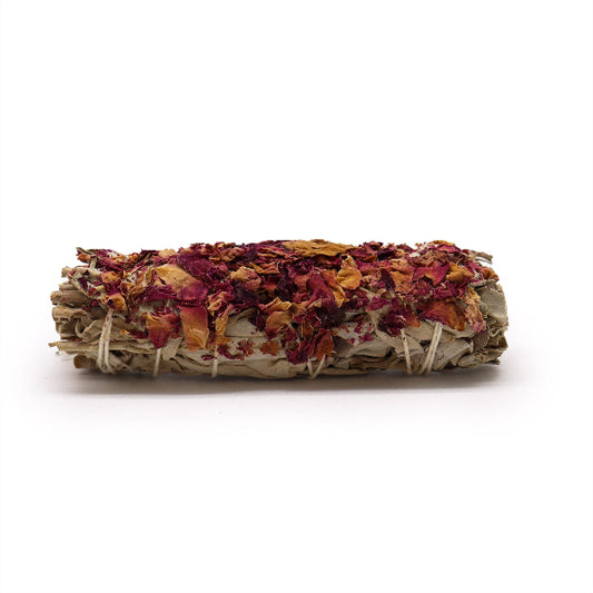Rolled sage smudge stick with colorful dried leaves on a white background