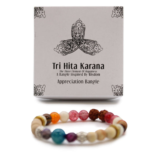 Tri Hita Karana bracelet with packaging on a white background