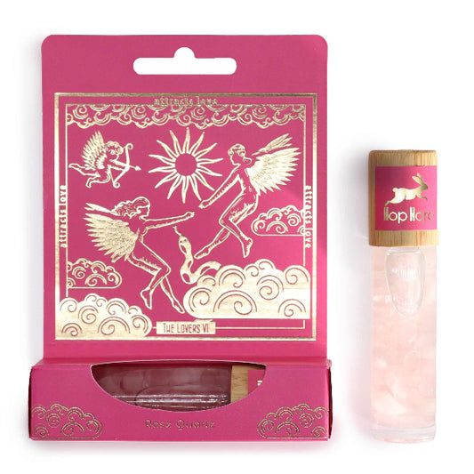 Pink packaging with angel designs and a small bottle labeled 'Lollipop' on a white background
