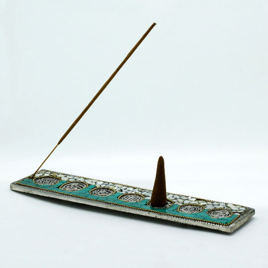 Incense holder with two incense sticks on a white background