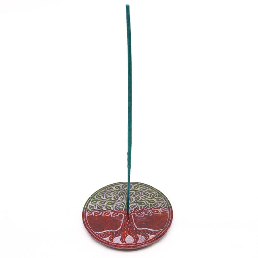 Decorative incense holder with tree design on a white background