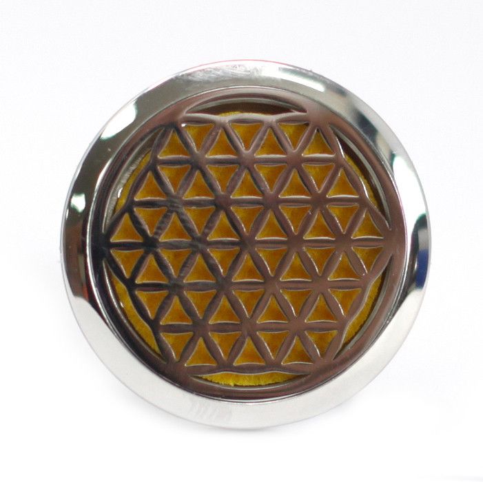 Decorative metal button with geometric pattern on a white background