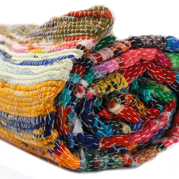 Stack of colorful fabric rolls on a white background