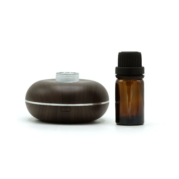 Wooden diffuser and amber glass bottle on a white background