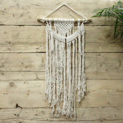 Macrame wall hanging on a wooden wall