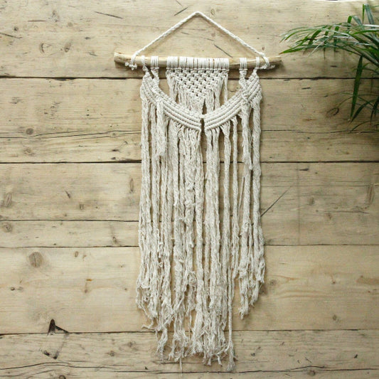 Macrame wall hanging on a wooden wall