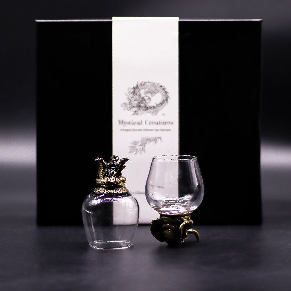 Decorative glass items with a black box labeled 'Mystical Creatures' on a dark background