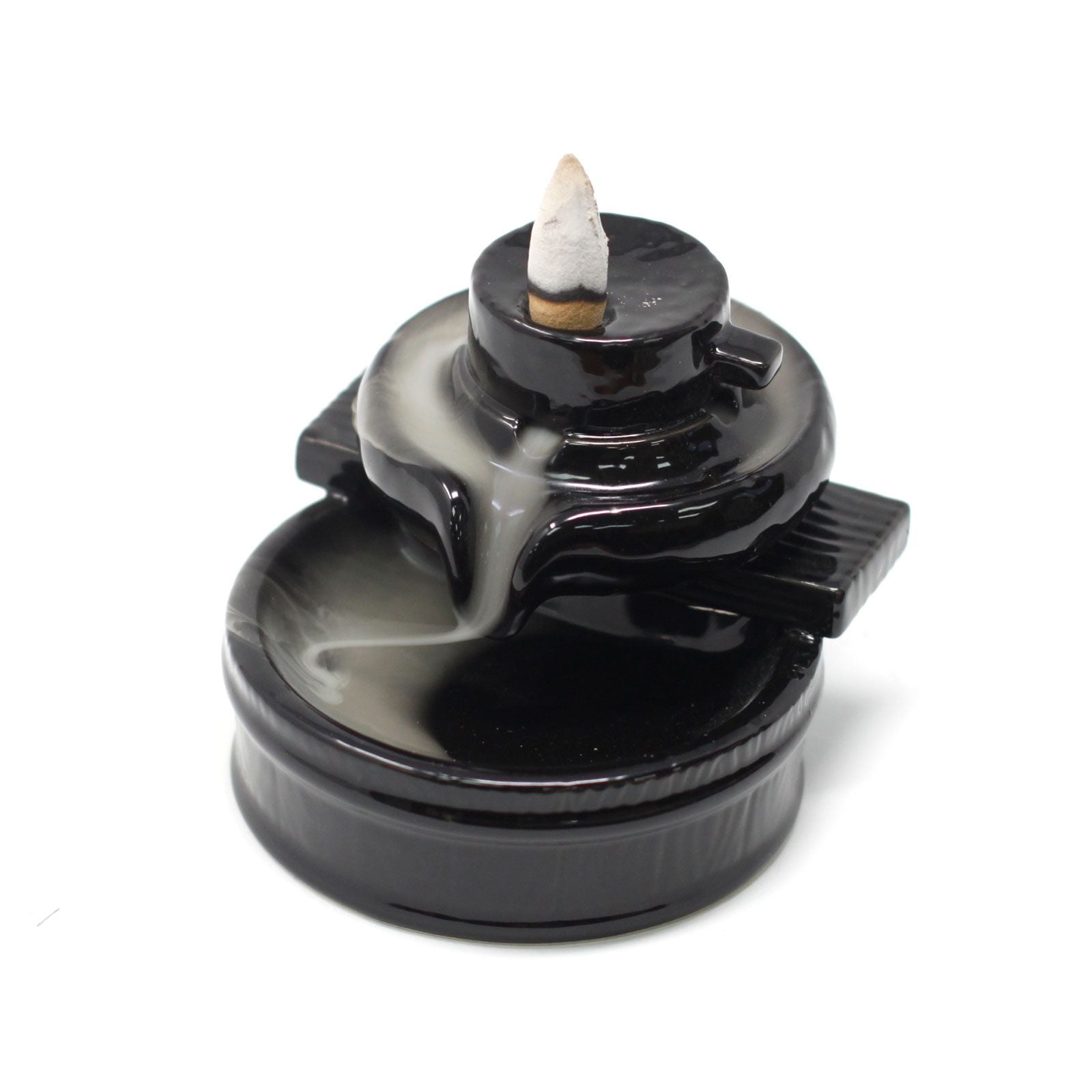 Black incense burner with a white incense stick on a white background