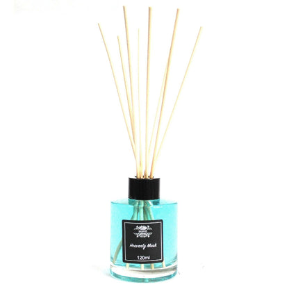 Reed diffuser with wooden sticks in a clear bottle on a white background