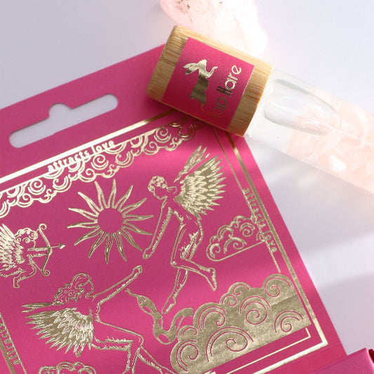 Pink packaging with gold designs and a roll of tape on a white background