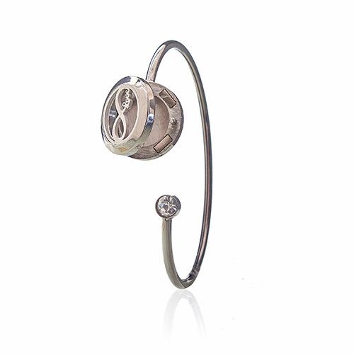 Silver bracelet with a circular clasp and a small gemstone on a white background