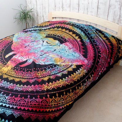 Colorful tapestry with a lion design on a bed in a room.