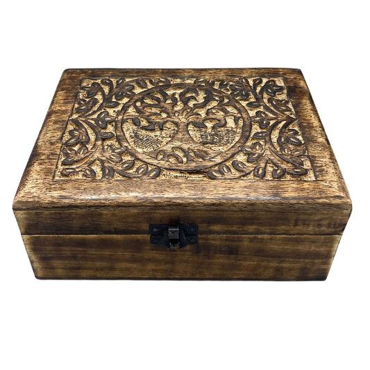 Wooden box with intricate carvings on a white background