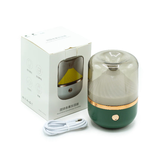 Green humidifier with packaging and cable on a white background