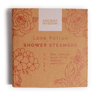 Box of 'Love Potion' shower steamers with floral designs and 'Ancient Wisdom' branding.
