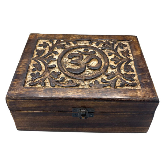 Wooden box with Om symbol and floral patterns on a white background
