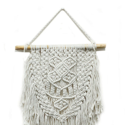Macrame wall hanging with geometric pattern on a white background
