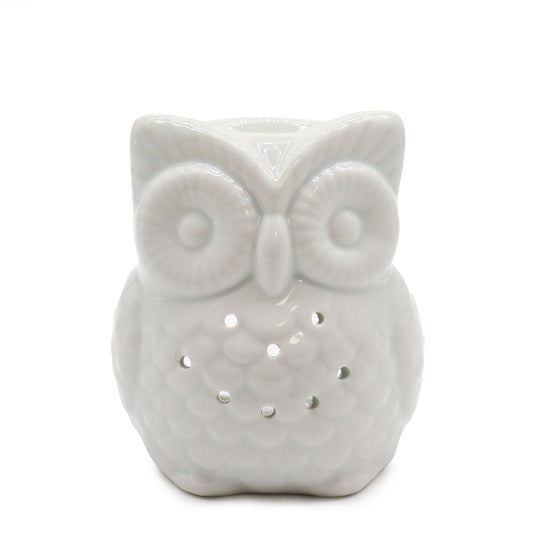 White ceramic owl-shaped night light on a white background