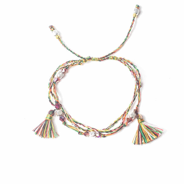 Colorful braided bracelet with tassels on a white background