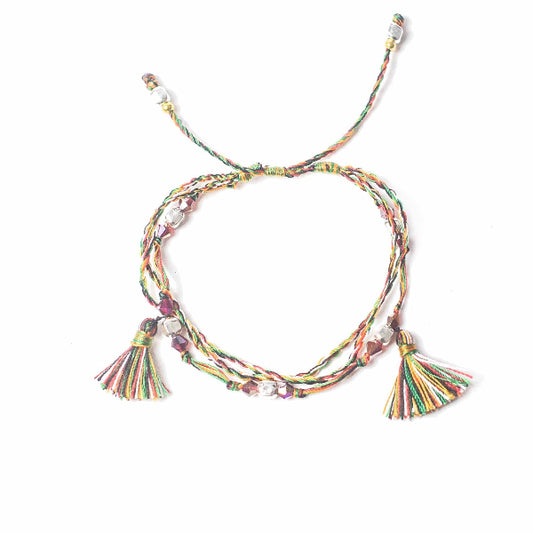 Colorful braided bracelet with tassels on a white background