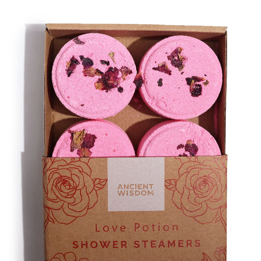 Four pink shower steamers with dried flowers in a 'Ancient Wisdom' box.