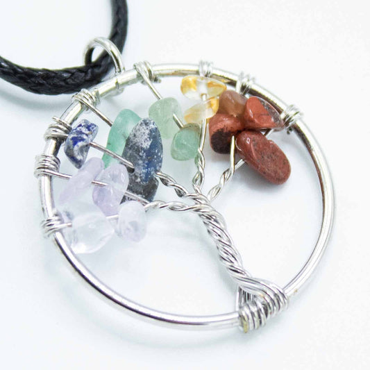 Tree-shaped pendant with multicolored stones on a white background