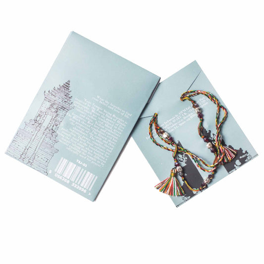 Colorful braided bracelet on a light blue card with text