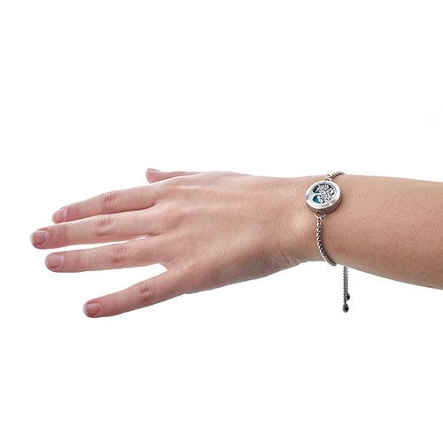 Hand wearing a bracelet on a white background
