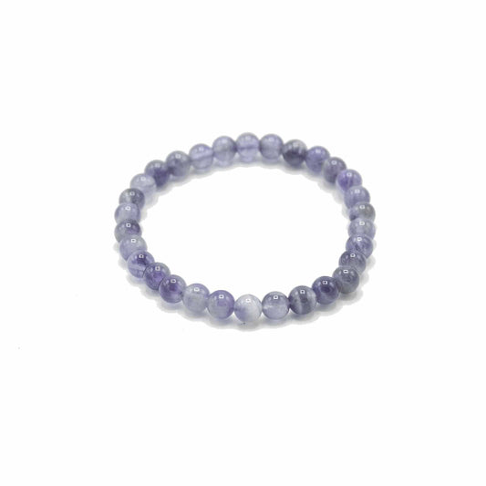 Beaded bracelet with purple and white stones on a white background