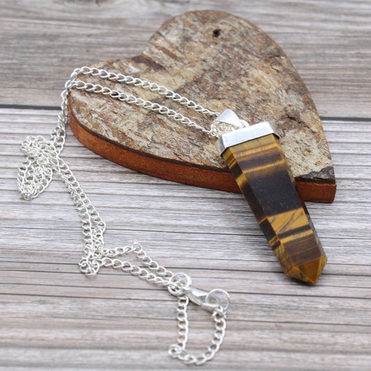 Tiger's eye crystal necklace on a wooden surface