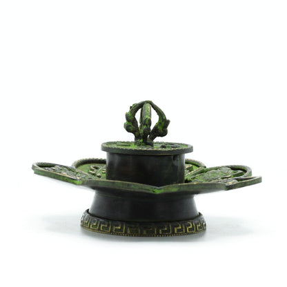 Decorative green and black object on a white background
