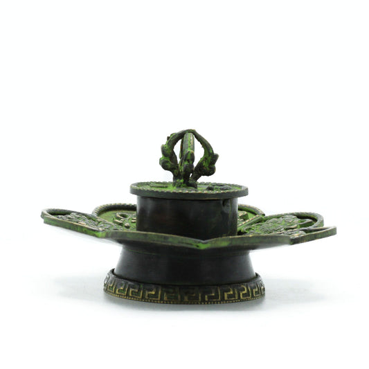 Decorative green and black object on a white background