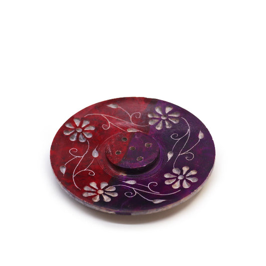 Round decorative item with floral patterns on a white background