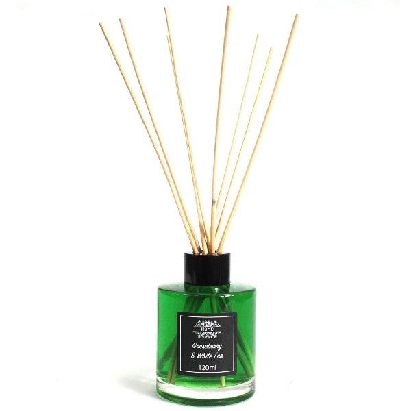 Green diffuser bottle with wooden sticks on a white background