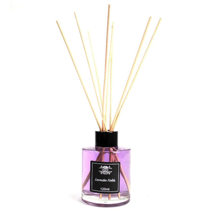 Reed diffuser with wooden sticks in a clear bottle on a white background