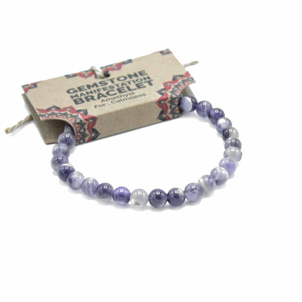 Purple beaded bracelet on a white background with a branded card behind it