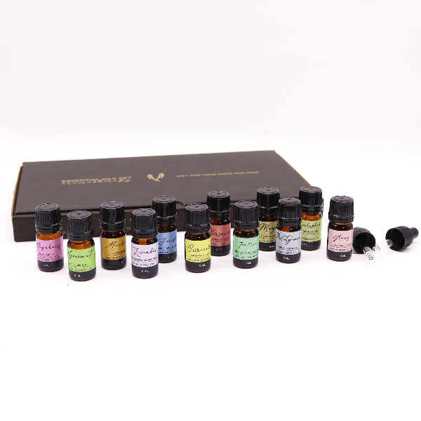 Set of essential oil bottles with labels on a white background