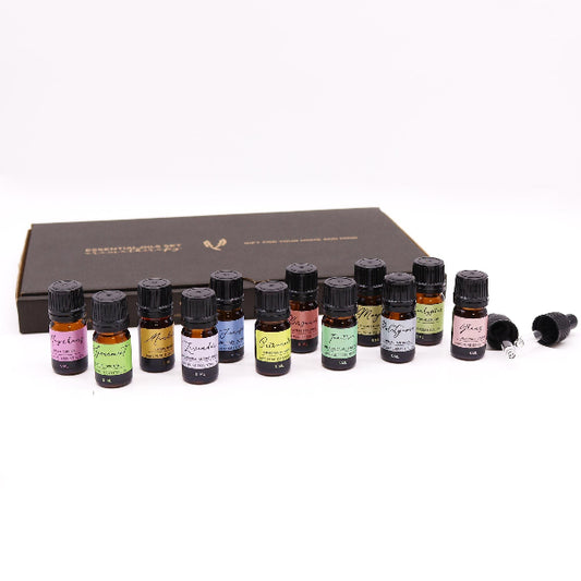 Set of essential oil bottles with labels on a white background