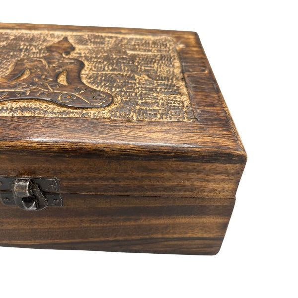 Wooden box with engraved design on a white background