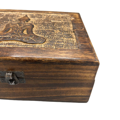 Wooden box with engraved design on a white background