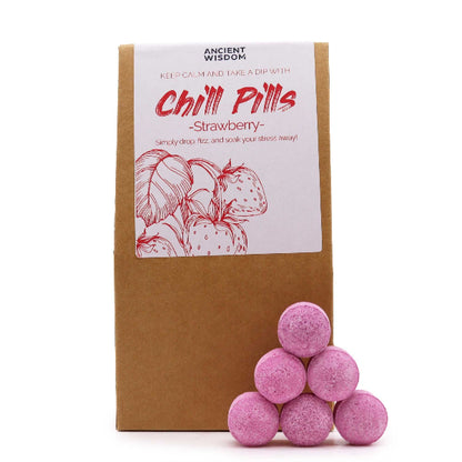 Pink bath bombs with a cardboard box labeled 'Chill Pills - Strawberry' on a white background