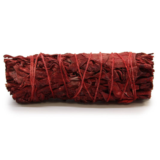 Red sage bundle tied with red string on a white background
