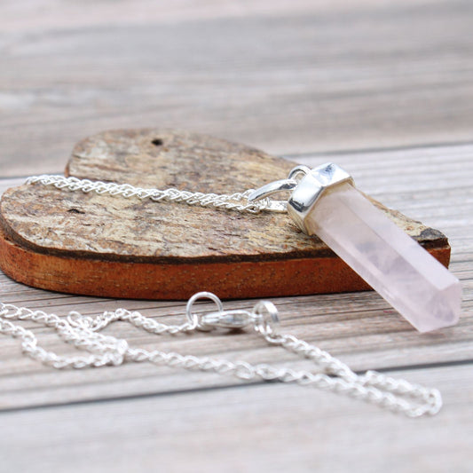 Crystal pendant necklace on a wooden surface