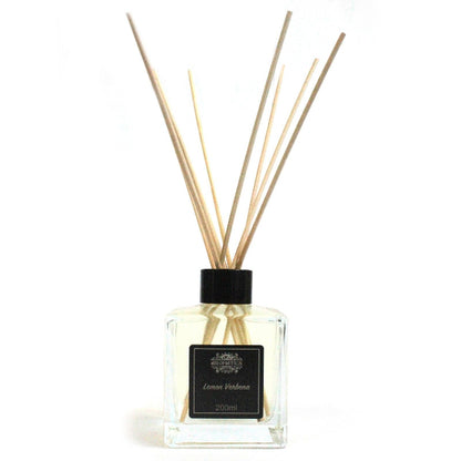 Diffuser with reeds and a clear bottle on a white background