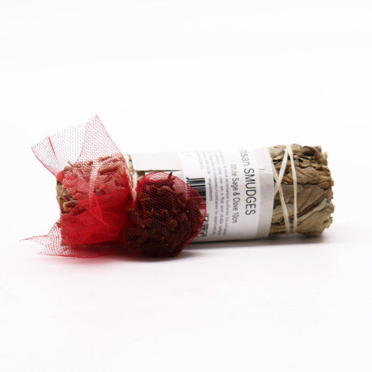 Sage smudge stick with red tulle on a white background