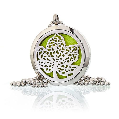 Silver locket with a leaf design on a white background