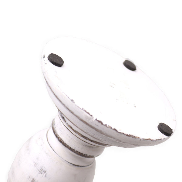 White decorative pedestal with black accents on a white background