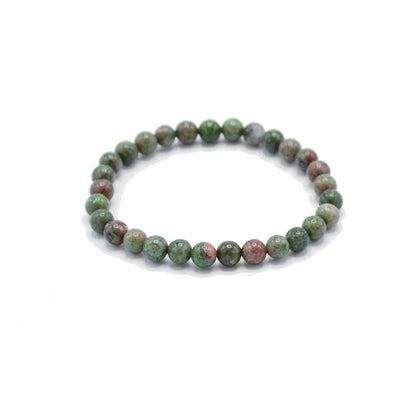Green beaded bracelet on a white background